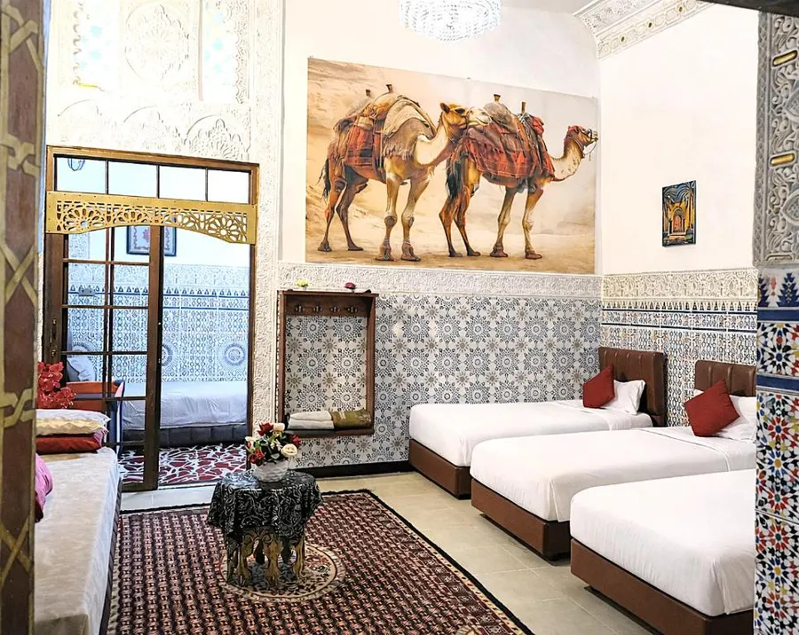 Family Suite with zellige walls, a camel painting and several beds